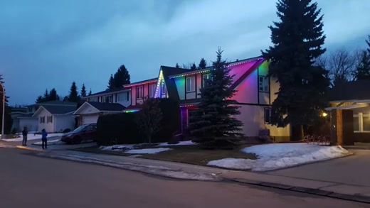 Lit homes on a snowy Edmonton street